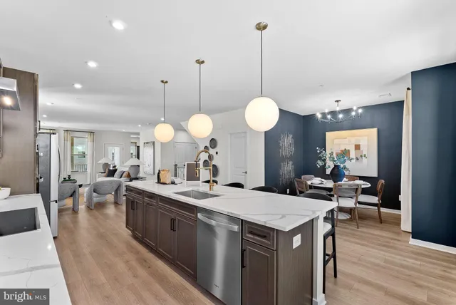 a view of a kitchen counter space a sink appliances and living room view