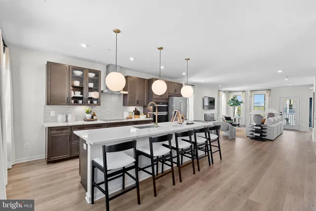 a large kitchen with a table and chairs