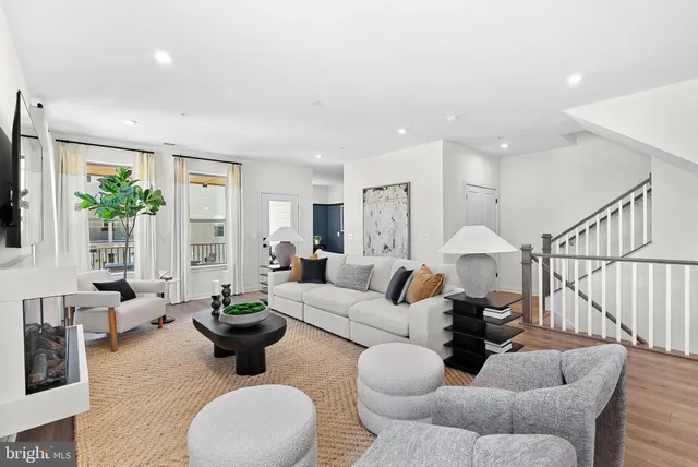 a living room with furniture potted plant and a window