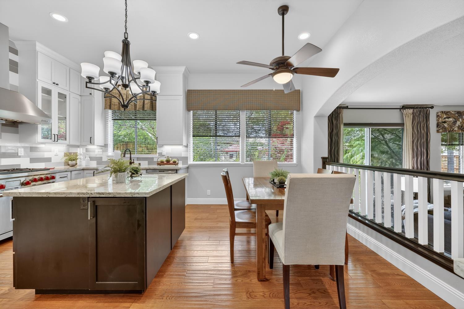 1203 Halidon Way Folsom, CA 95630 - Photo 13 of 98 a dining room with wooden floor a chandelier fan a wooden floor and a chandelier