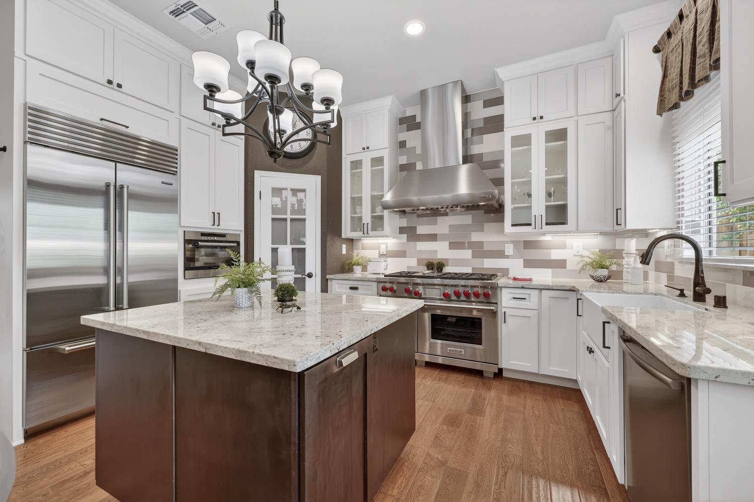 1203 Halidon Way Folsom, CA 95630 - Photo 16 of 98 a kitchen with stainless steel appliances granite countertop a sink stove and refrigerator