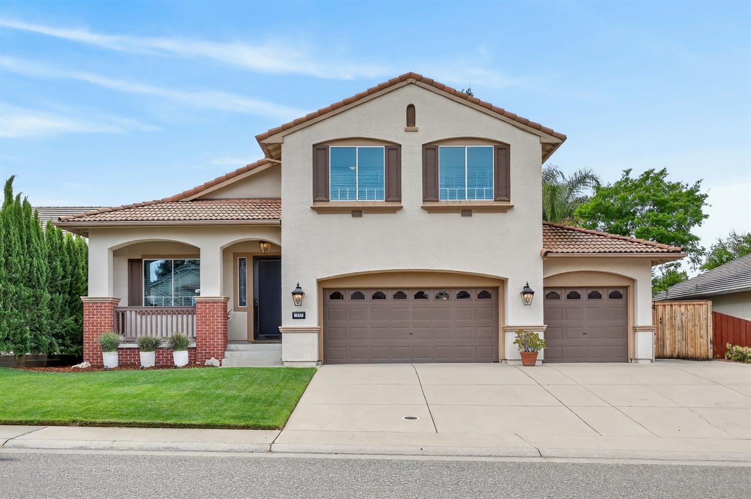 1203 Halidon Way Folsom, CA 95630 - Photo 2 of 98 a front view of a house with a garden and garage
