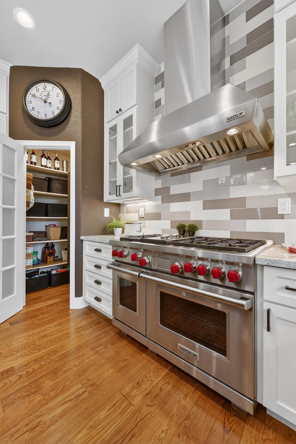 1203 Halidon Way Folsom, CA 95630 - Photo 22 of 98 a kitchen with stainless steel appliances a stove and cabinets