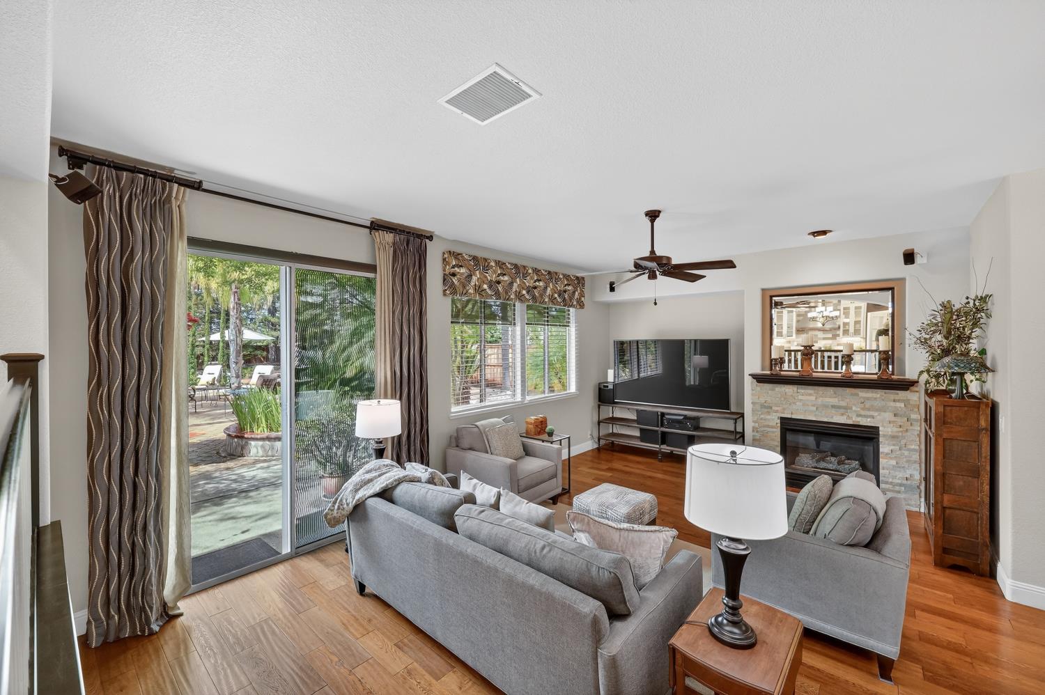 1203 Halidon Way Folsom, CA 95630 - Photo 23 of 98 a living room with furniture a fireplace and a flat screen tv