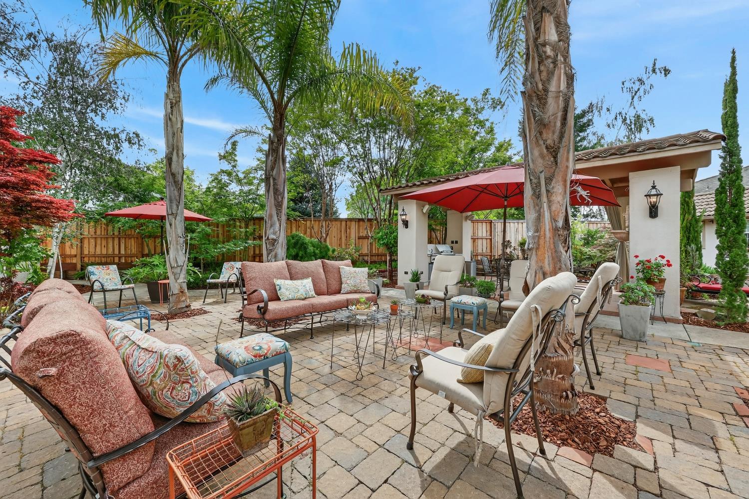 1203 Halidon Way Folsom, CA 95630 - Photo 60 of 98 a view of a patio with a dining table and chairs under an umbrella with a fire pit