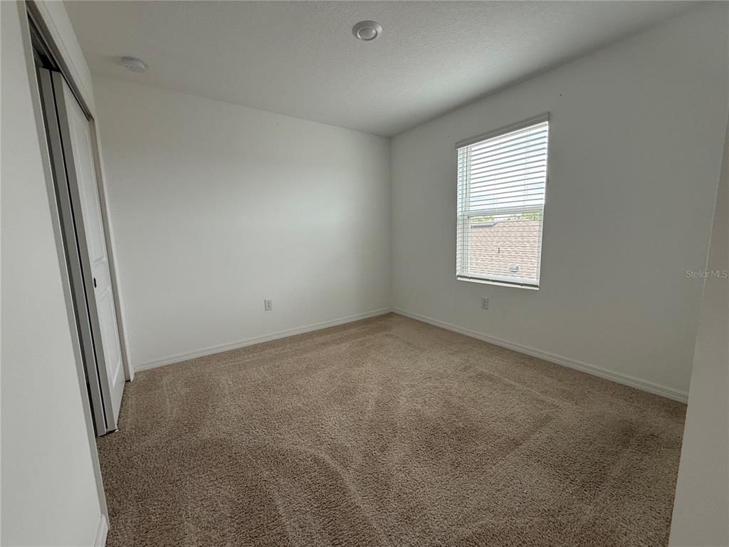 6431 Milestone Loop Palmetto, FL 34221 - Photo 16 of 28 an empty room with windows