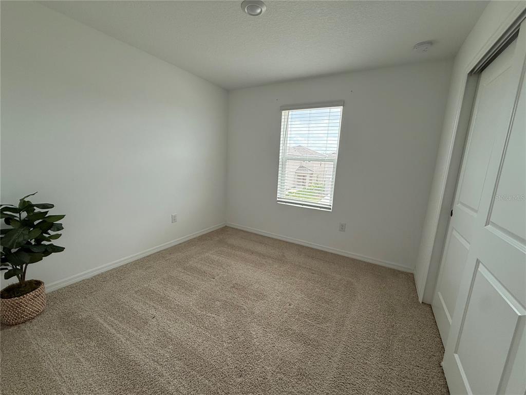 6431 Milestone Loop Palmetto, FL 34221 - Photo 17 of 28 an empty room with a window