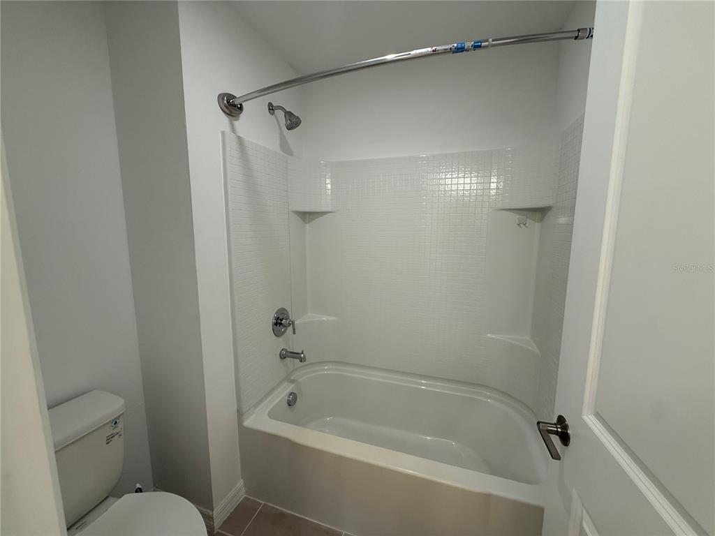 6431 Milestone Loop Palmetto, FL 34221 - Photo 20 of 28 a bathroom with a shower and a toilet