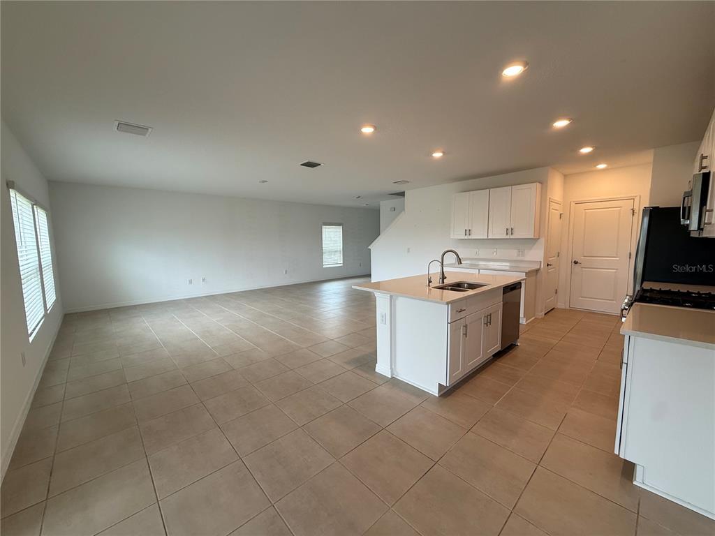 6431 Milestone Loop Palmetto, FL 34221 - Photo 3 of 28 a large kitchen with stainless steel appliances a large counter top a stove and a refrigerator