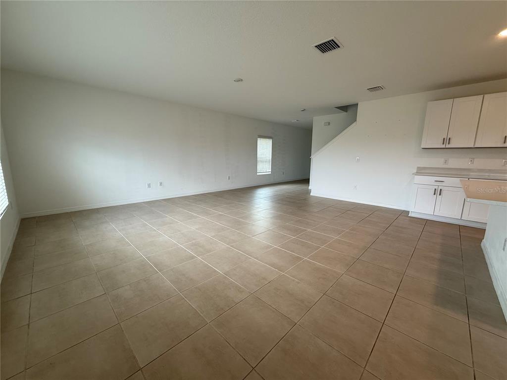 6431 Milestone Loop Palmetto, FL 34221 - Photo 4 of 28 a view of a kitchen with cabinet and an empty room