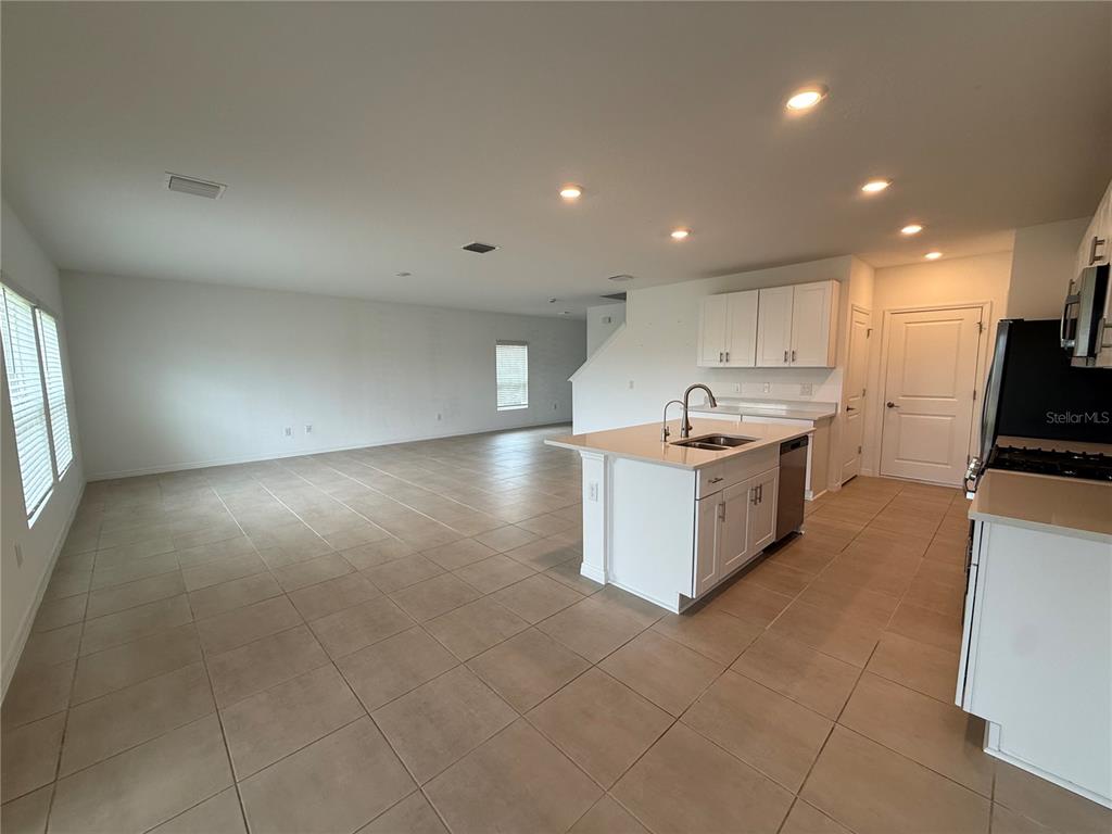 6431 Milestone Loop Palmetto, FL 34221 - Photo 5 of 28 a large kitchen with stainless steel appliances a large counter top and a stove top oven