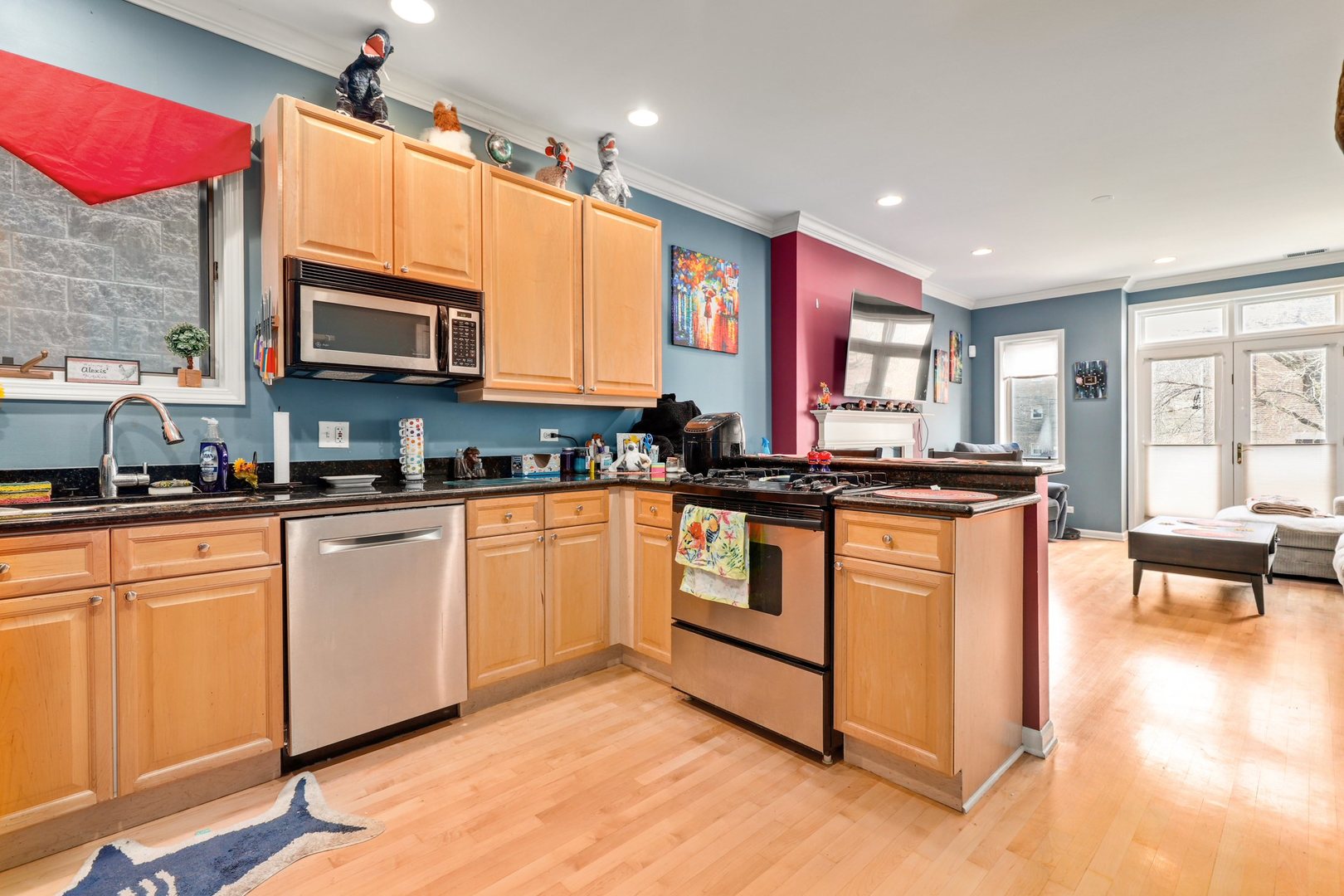 952 West Barry Avenue, Unit 1 Chicago, IL 60657 - Photo 5 of 11 a kitchen with stainless steel appliances granite countertop a stove a sink and a microwave