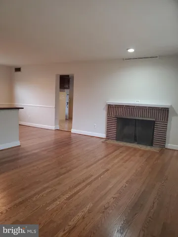 a view of an empty room with glass door and balcony