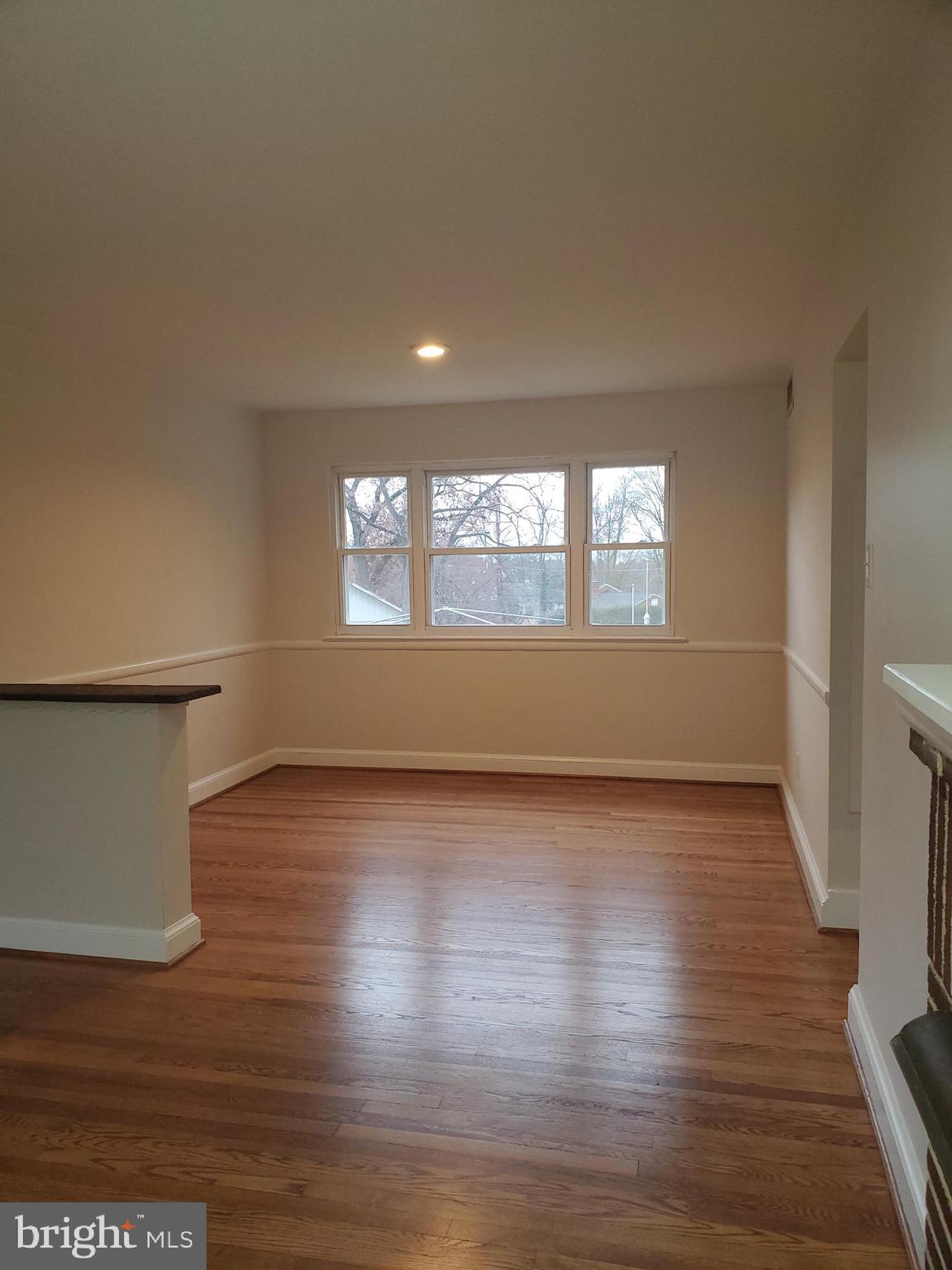 3311 Powder Mill Road Hyattsville, MD 20783 - Photo 15 of 33 an empty room with wooden floor and windows