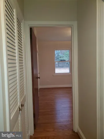 a view of hallway with wooden floor