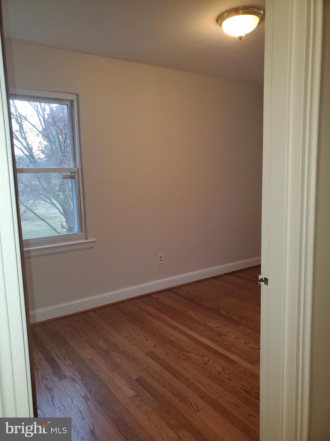 3311 Powder Mill Road Hyattsville, MD 20783 - Photo 19 of 33 a view of an empty room with wooden floor and a window