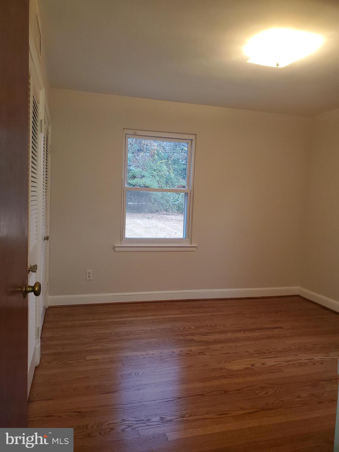 3311 Powder Mill Road Hyattsville, MD 20783 - Photo 21 of 33 an empty room with wooden floor and windows