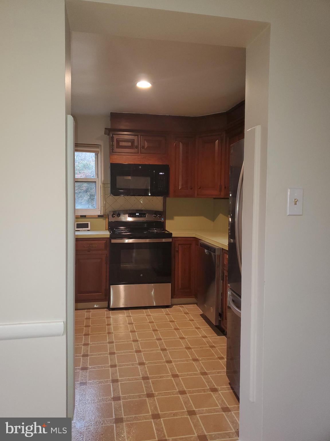 3311 Powder Mill Road Hyattsville, MD 20783 - Photo 23 of 33 a kitchen with a stove and a refrigerator
