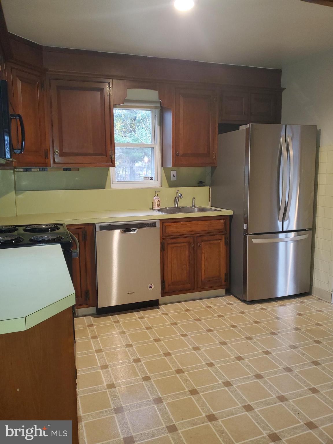 3311 Powder Mill Road Hyattsville, MD 20783 - Photo 25 of 33 a kitchen with stainless steel appliances granite countertop a refrigerator sink and cabinets