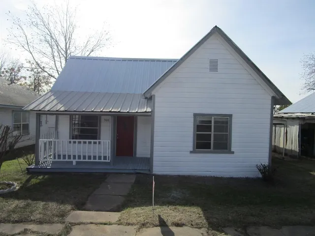 a front view of a house with yard