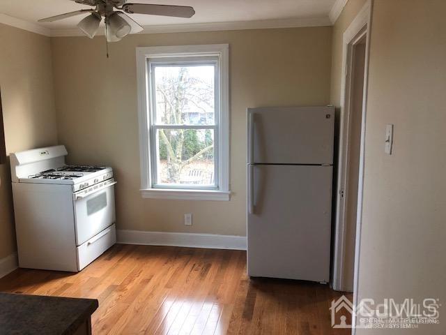 112 East Street Bound Brook, NJ 08805 - Photo 12 of 28 a kitchen with a refrigerator and a window