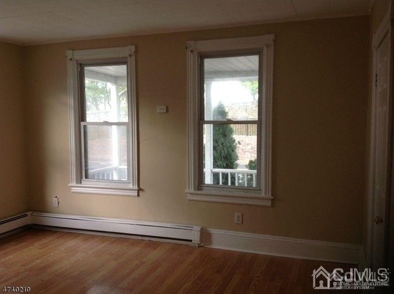 112 East Street Bound Brook, NJ 08805 - Photo 6 of 28 an empty room with wooden floor and windows
