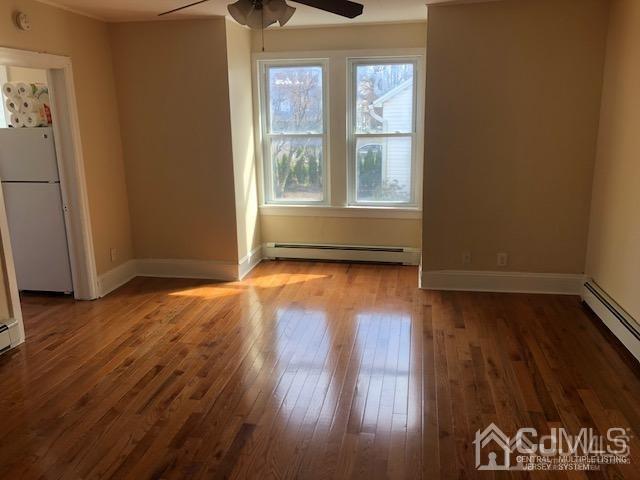 112 East Street Bound Brook, NJ 08805 - Photo 8 of 28 an empty room with wooden floor and windows