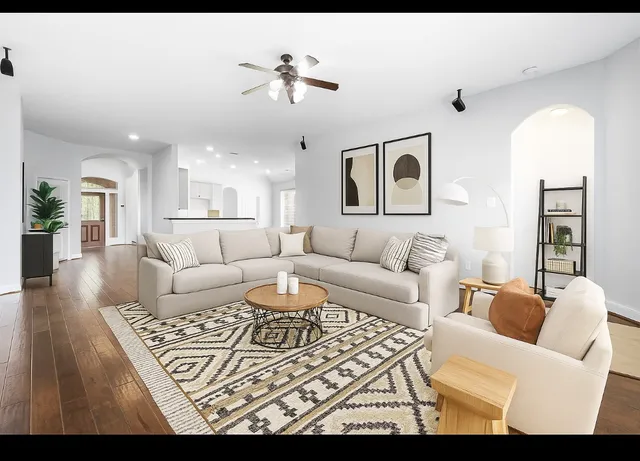 a living room with furniture and wooden floor