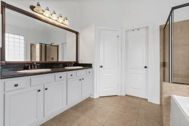 a bathroom with a double vanity sink and a mirror