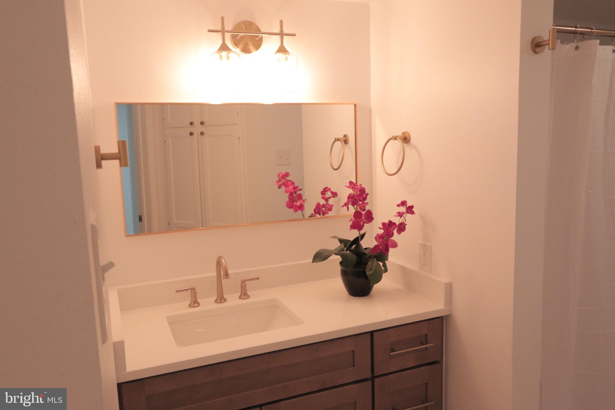 1504 Lincoln Way, Unit 104 McLean, VA 22102 - Photo 18 of 40 a bathroom with a sink and a mirror