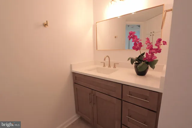 a bathroom with a sink and mirror