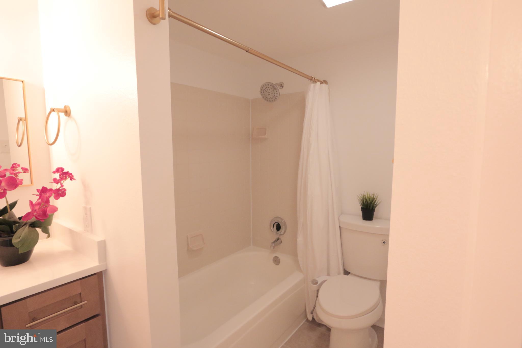 1504 Lincoln Way, Unit 104 McLean, VA 22102 - Photo 22 of 40 a bathroom with a sink toilet and shower