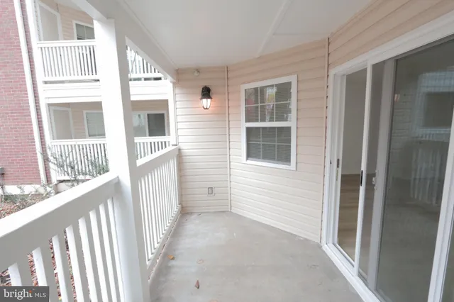 a view of a house with wooden fence and windows