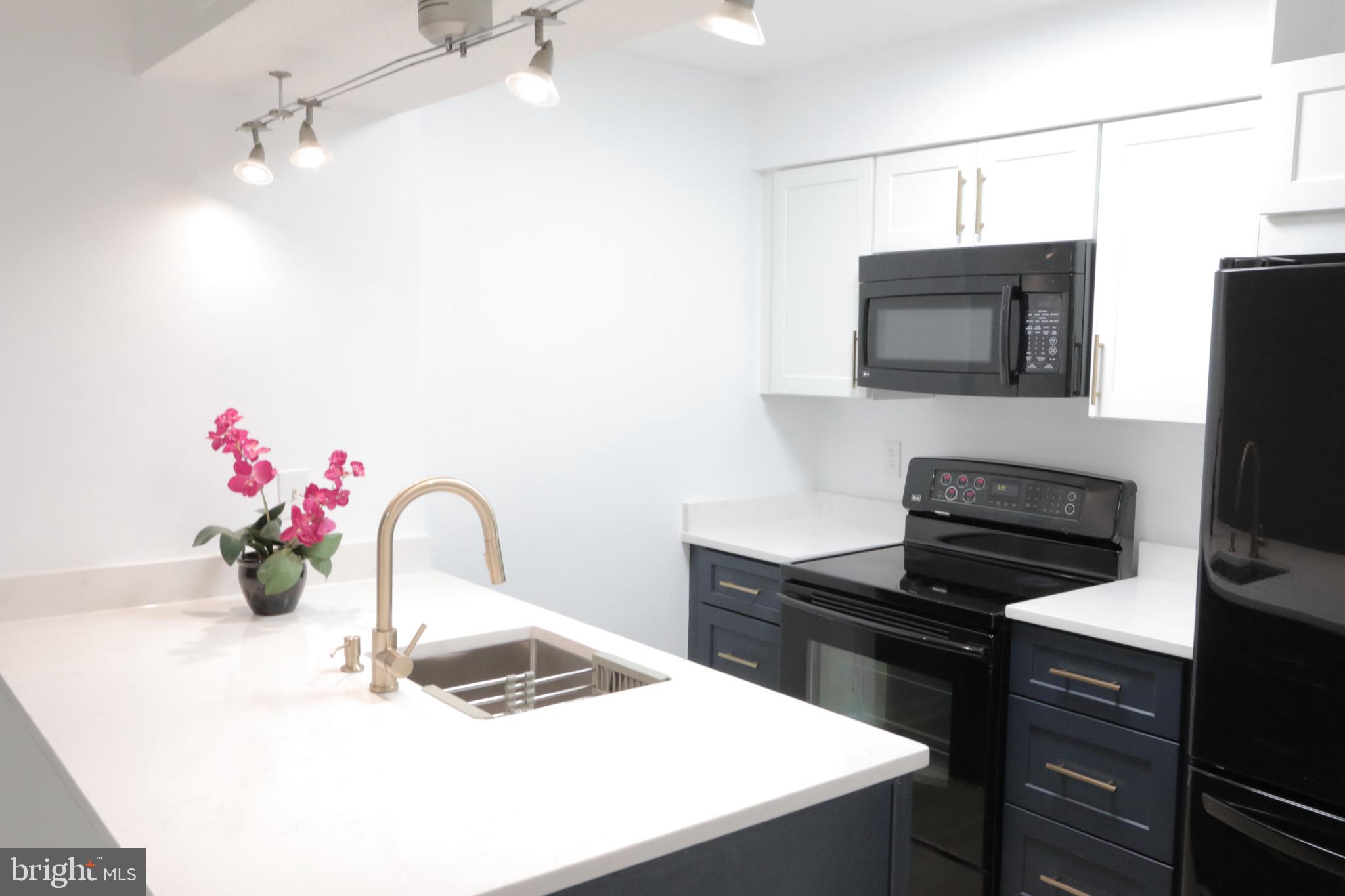 1504 Lincoln Way, Unit 104 McLean, VA 22102 - Photo 4 of 40 a kitchen with a sink and a microwave