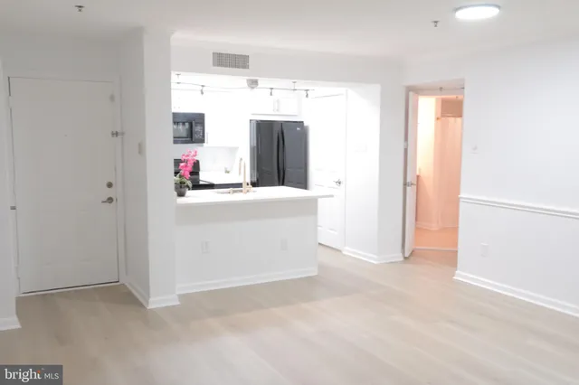 a utility room with cabinets washer and dryer