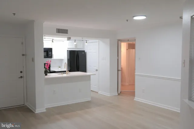 a kitchen with stainless steel appliances a refrigerator and a stove
