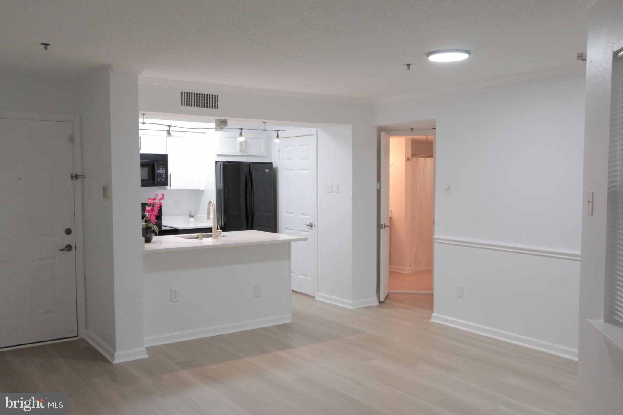 1504 Lincoln Way, Unit 104 McLean, VA 22102 - Photo 7 of 40 a kitchen with stainless steel appliances a refrigerator and a stove