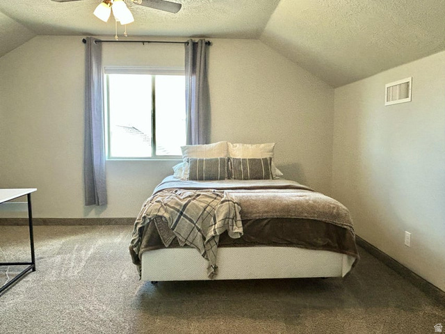 310 625 East Enterprise, UT 84725 - Photo 36 of 36 Sloped ceiling, window with curtain rod, ceiling fan with light fixture, carpeted flooring, and a wall-mounted vent