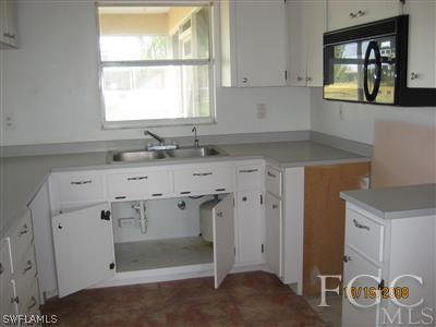 515 Southwest 29th Street Cape Coral, FL 33914 - Photo 2 of 3 a kitchen with a sink cabinets and window