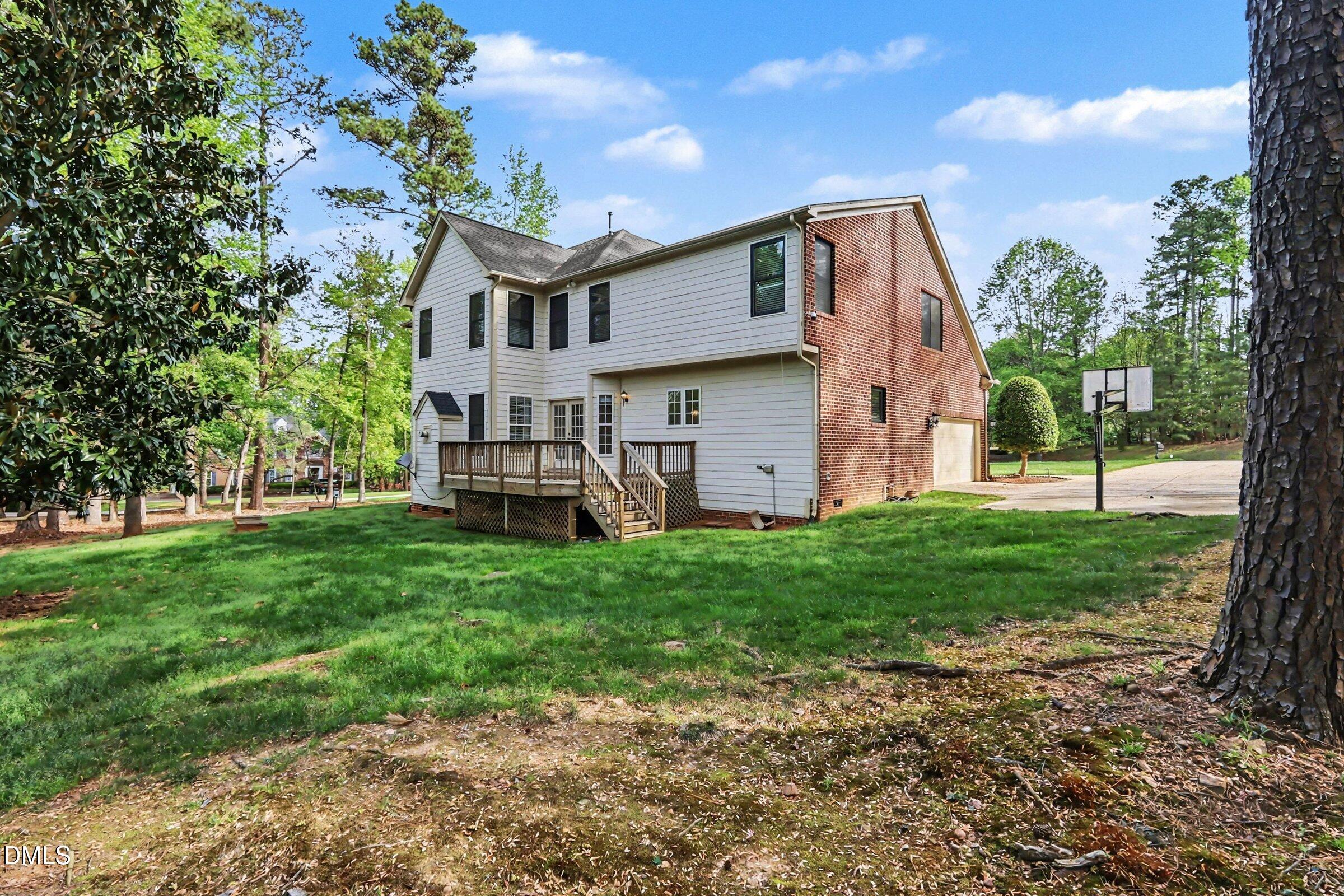 1001 Denfield Court Raleigh, NC 27615 - Photo 33 of 44 a view of a house with backyard and a tree