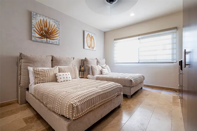 a bedroom with a bed and a painting on the wall