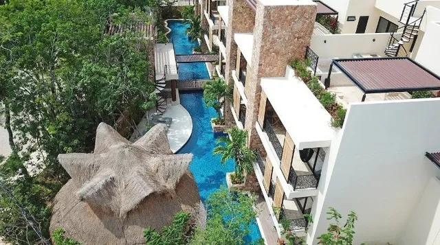 an aerial view of a house with outdoor seating