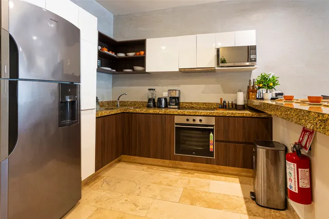a kitchen with stainless steel appliances granite countertop a refrigerator stove and sink