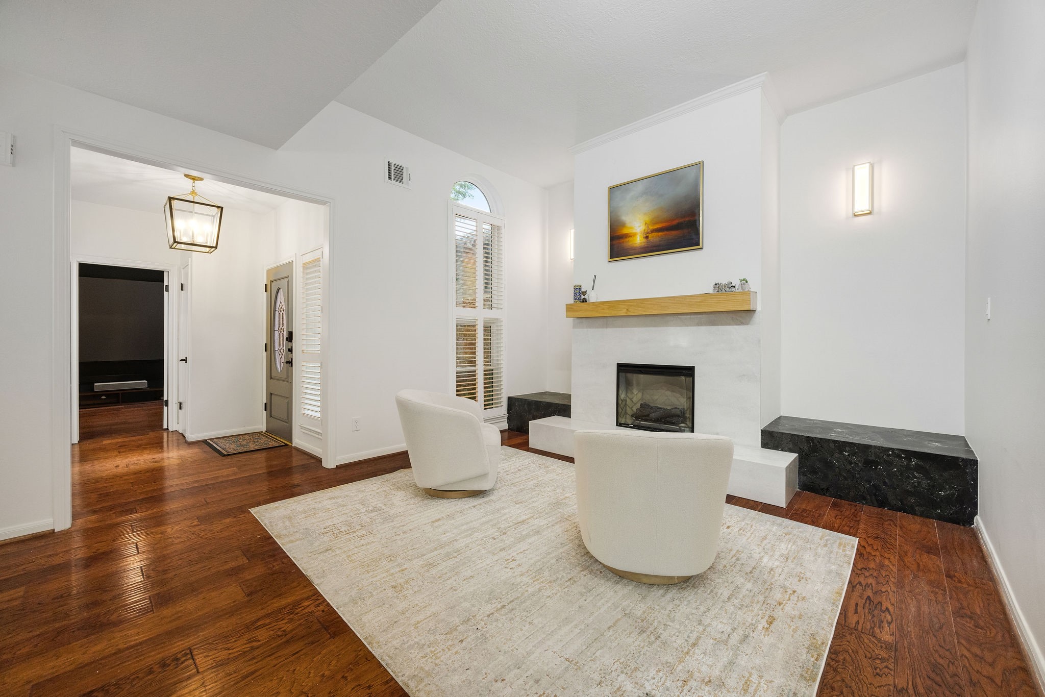 727 Bunker Hill Road, Unit 26 Houston, TX 77024 - Photo 3 of 25 This updated living room makes a statement with updated fireplace, high ceilings, updated light fixtures and wood flooring throughout.