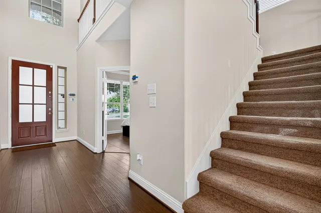 a view of an entryway with wooden floor and stairs