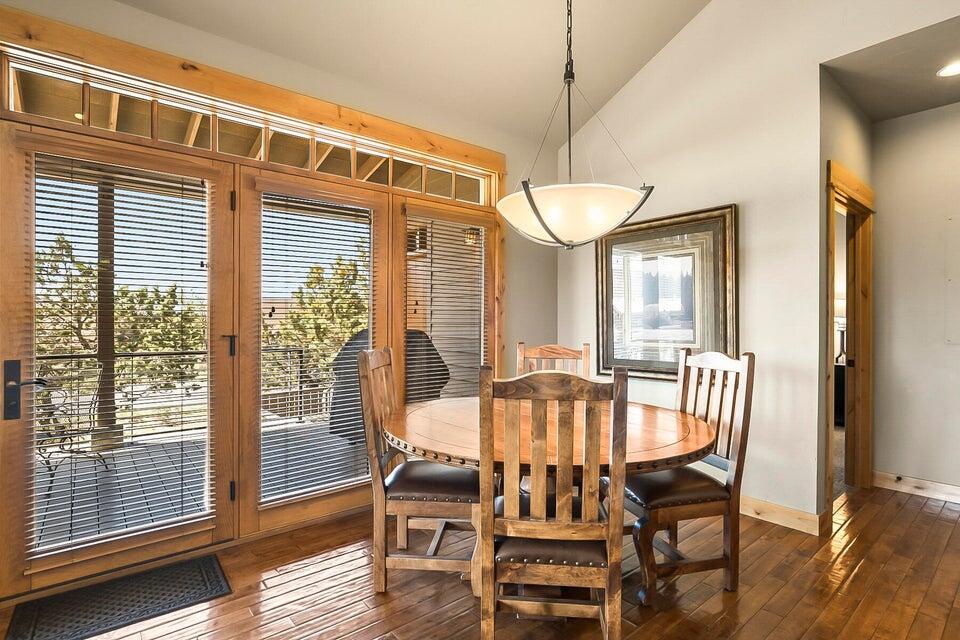 16845 South W Brasada Ranch Road, Unit 23 Powell Butte, OR 97753 - Photo 24 of 47 a view of a dining room with furniture wooden floor and chandelier
