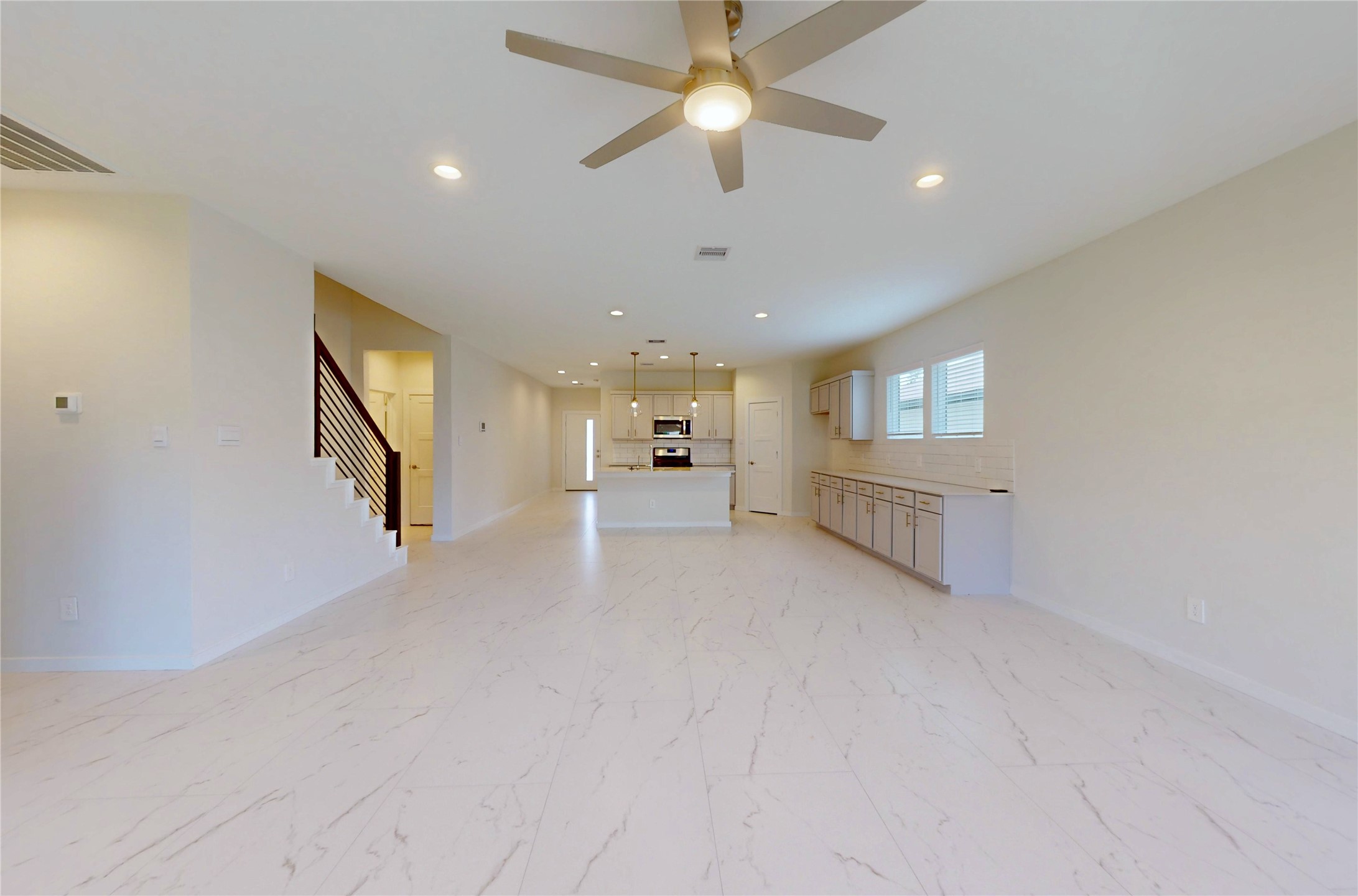 10428 Great Basin Lane Conroe, TX 77384 - Photo 5 of 28 a view of an empty room with a window and a kitchen
