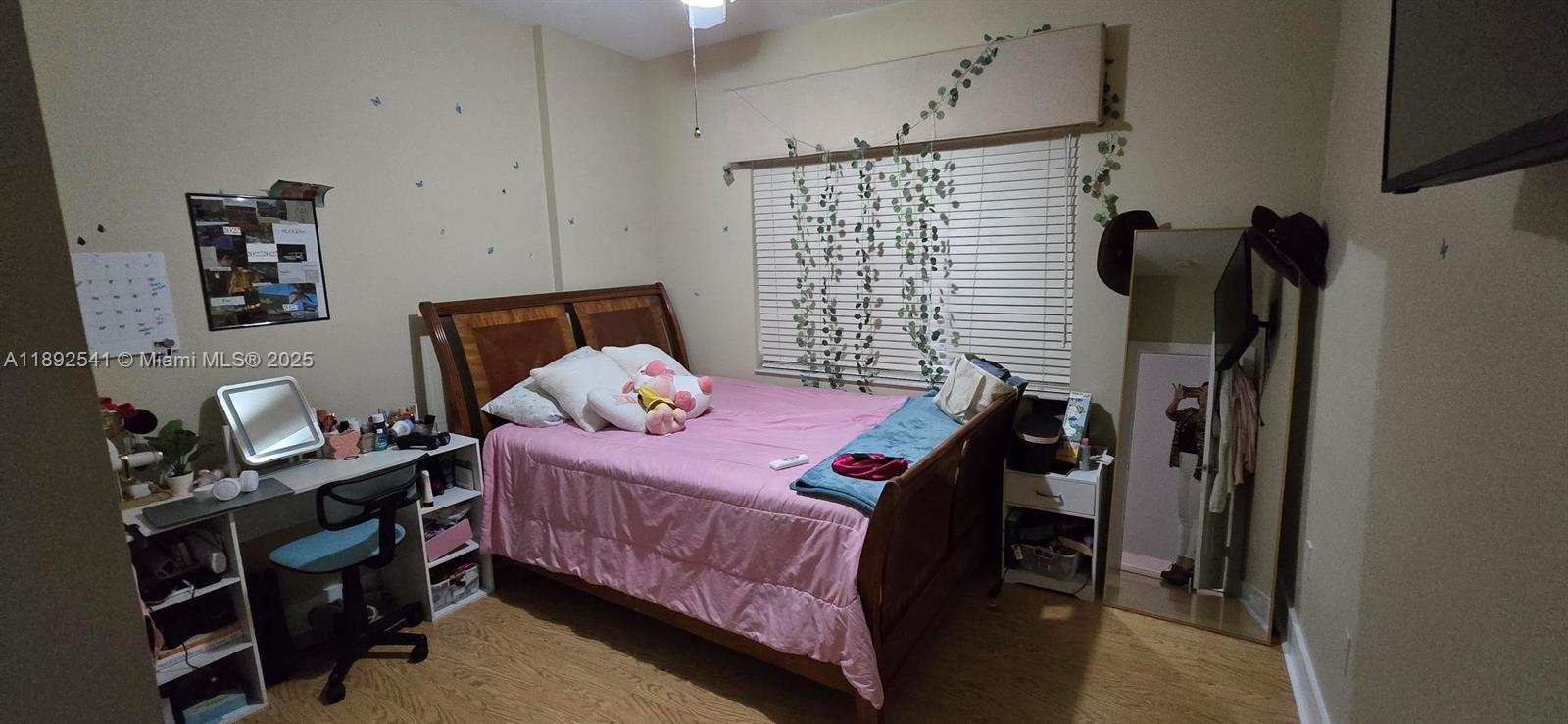 15982 Southwest 61st Street Davie, FL 33331 - Photo 19 of 28 a bedroom with a bed and a flat tv screen on the dresser