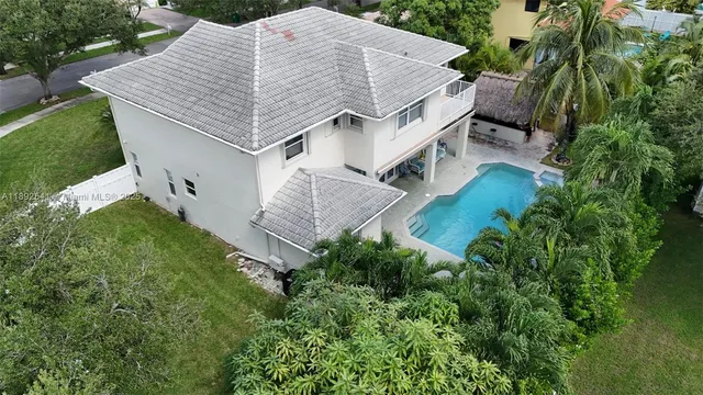 an aerial view of a house with a yard and trees