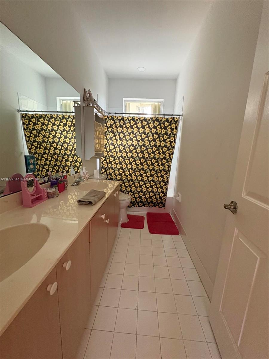 15982 Southwest 61st Street Davie, FL 33331 - Photo 21 of 28 a bathroom with a bathtub and shower